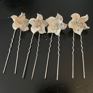 Four never worn Bridal hair pieces, flower shape with bling In the center.